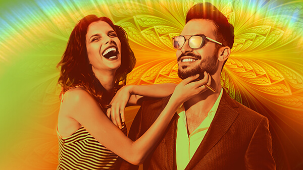 Woman holding MISTIFI Over The Rainbow Premium Cannabis Vape Pen leaning on smiling man wearing sunglasses